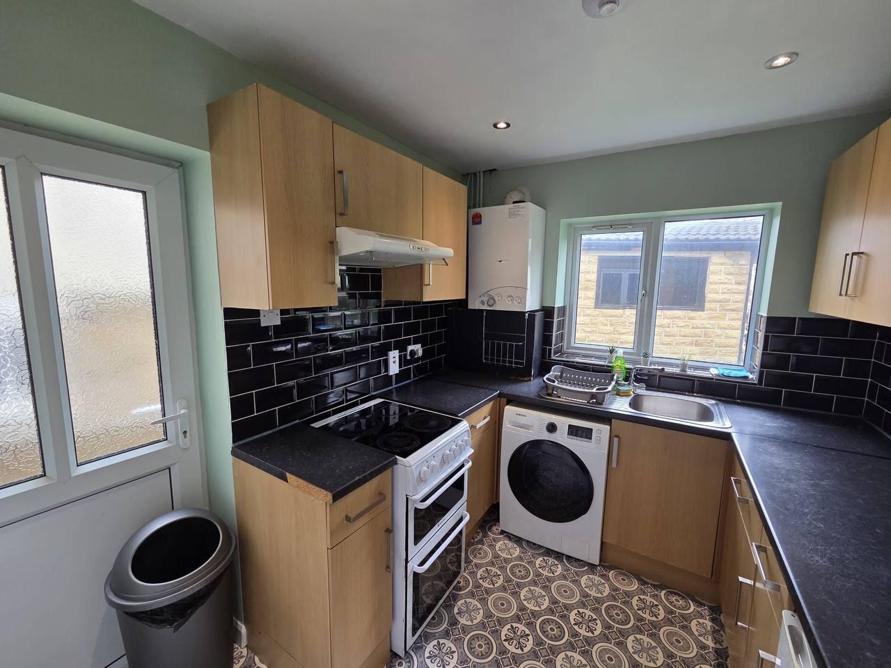 Kitchen with fridge-freezer, oven and a patterned tile floor — Lynton Avenue 5a, Huddersfield