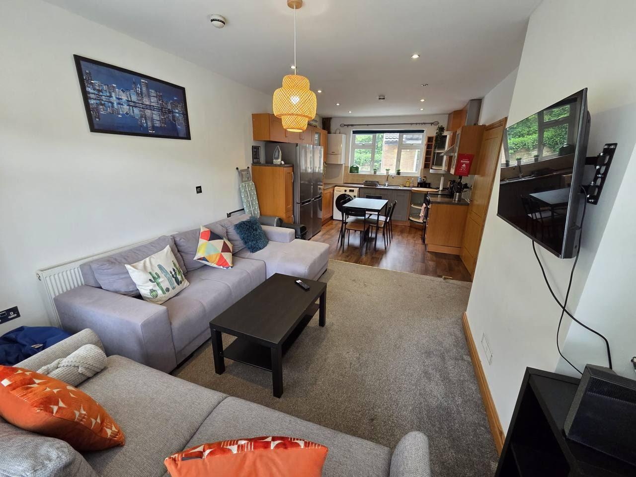 Bright open-plan living room and kitchen with sofas and dining table — Greenhead Road, Huddersfield