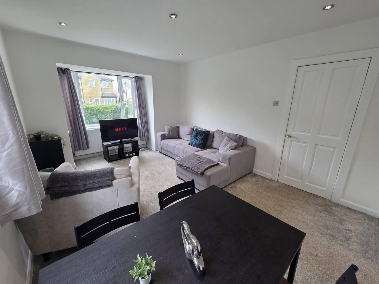 Lounge with a corner sofa opening onto the dining space — Lynton Avenue 5a, Huddersfield