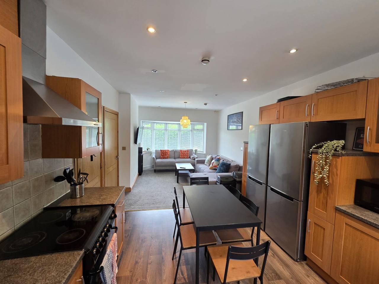 Kitchen and dining area with wood flooring and a large window — Greenhead Road, Huddersfield